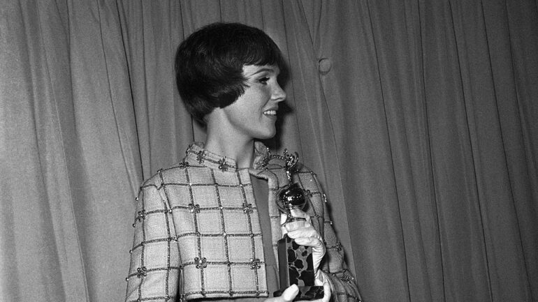 (Original Caption) Actress Julie Andrews holds her Golden Globe Award of the Hollywood Foreign Press Association after being named the world's favorite film actress for the second consecutive year. Paul Newman was named the world's most popular actor.