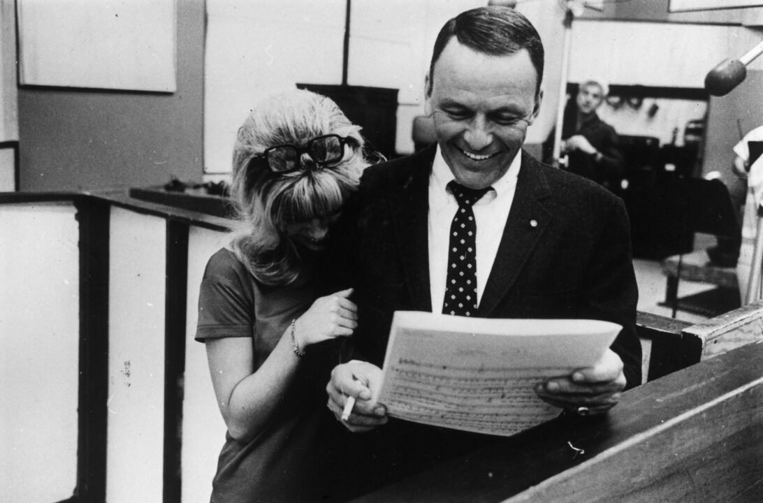March 1967: Frank Sinatra (1915 - 1998) sharing a joke with his daughter, Nancy during a joint recording session in Hollywood. 