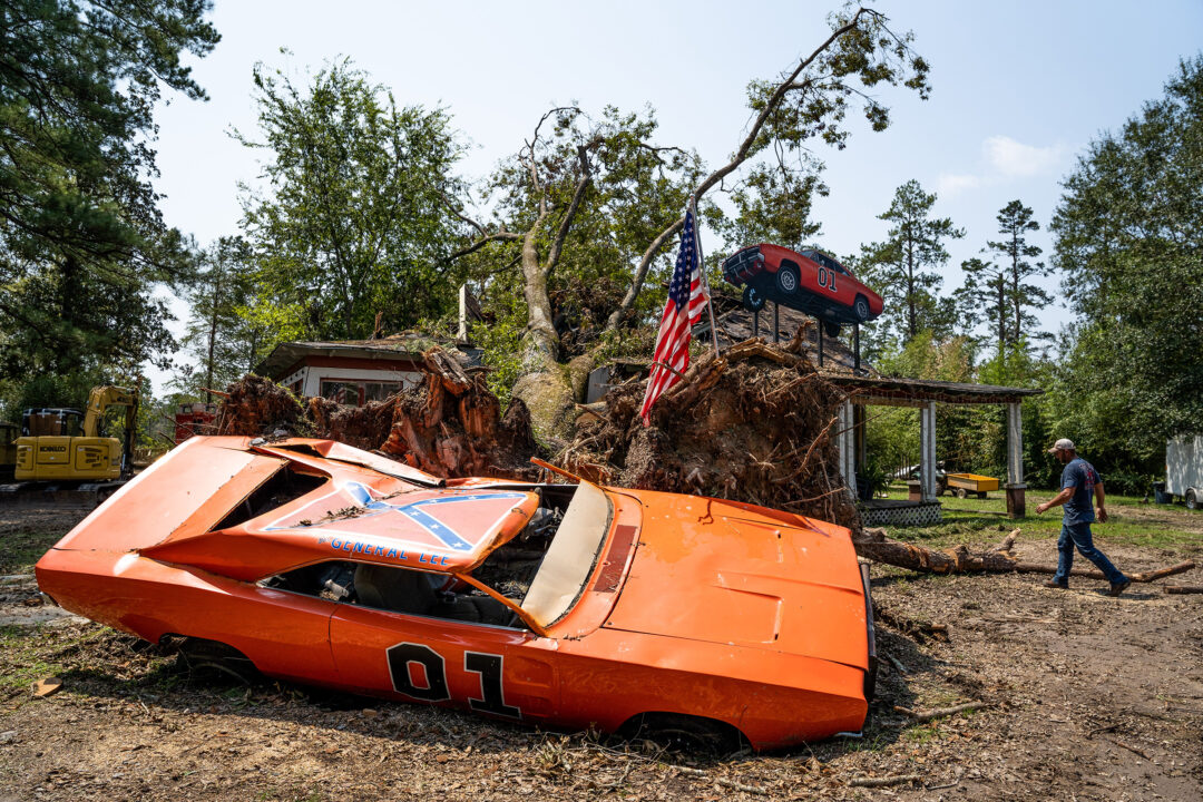 HOLDEN, LA - SEPTEMBER 2: A man walks near a General Lee car, damaged by Hurricane Ida, at the John Schneider Studios on September 2, 2021 in Holden, Louisiana. Schneider is best known for his role as Bo Duke in "The Dukes of Hazzard" television series. Although not used in the series, the vehicle saw time in the film "Christmas Cars." Ida made landfall as a Category 4 hurricane Sunday in Louisiana, bringing flooding, wind damage and power outages along the Gulf Coast. 