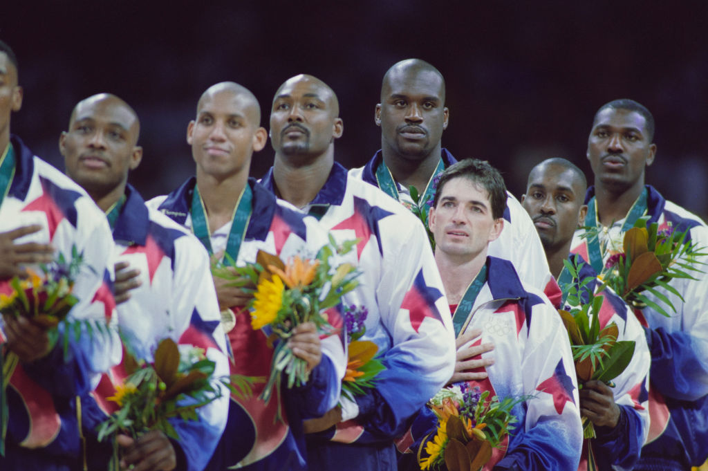 L - R, Mitch Richmond, Reggie Miller, Karl Malone, John Stockton, Shaquille O'Neal, Gary Payton and Hakeem Olajuwon of the United States Men's basketball team stand on the podium to sing the national anthem after winning the gold medal in the final game of the Men's Olympic Basketball Tournament against Yugoslavia at the XXVI Summer Olympic Games on 3rd August 1996 at the Georgia Dome in Atlanta, Georgia, United States. The United States won the game and tournament 95 - 69