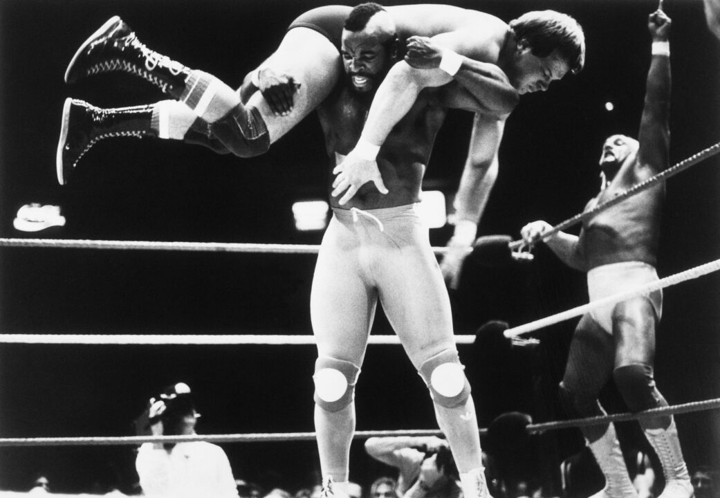 (Original Caption) New York: Wrestling champion Hulk Hogan (Right) shows enthusiasm as television's Mr. T, his partner in a tag team wrestling match, gets Rowdy Roddy Piper up on his shoulders for a slam to the mat 3/31. Hogan and Mr. T beat Piper and Paul Orndorff in the main event of a big wrestling program.