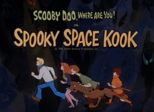 title card from the 1969 "Spooky Space Kook" episode of "Scooby-Doo, Where Are You!" Beneath the title of the show in a green font at the top is the title of the episode, in larger yellow font. Below that are the characters (from left) Fred, Daphne, Shaggy, Scooby-Doo and Velma, running.