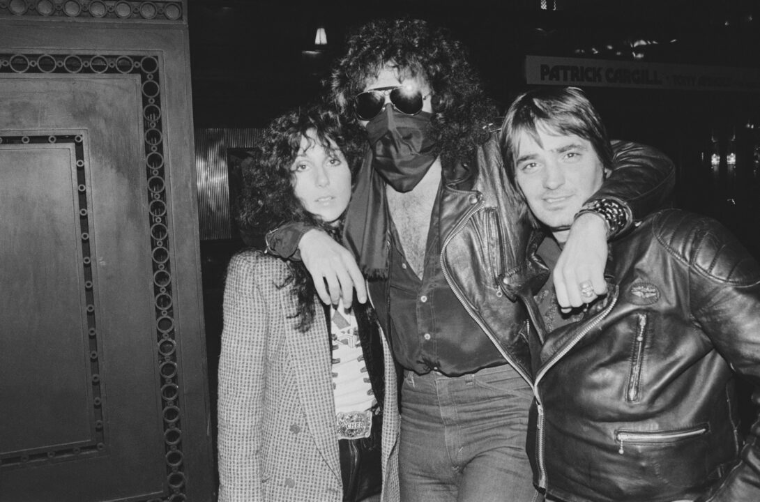 American singer and actress Cher with former boyfriend Israeli-American musician Gene Simmons of rock group Kiss, UK and an unknown friend, 11th April 1978. 