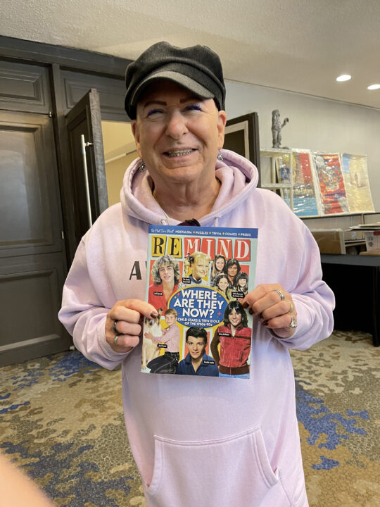 Larry Mathews holding ReMIND Magazine