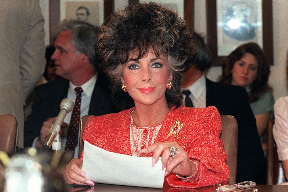 Movie star Elizabeth Taylor smiles as she appears before the Labor, Health and Human services Senate Subcommittee on May 8, 1986 in Washington. Liz Taylor appears as chairman of the American Foundation for Aids Research and appealed for more funds for AIDS research.