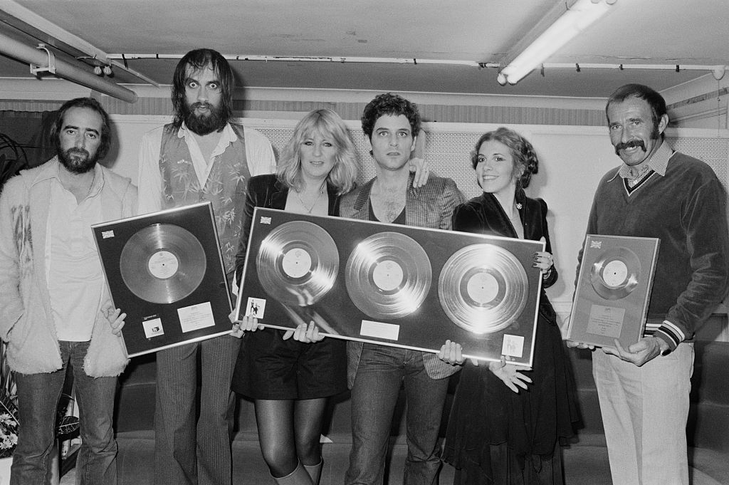 Anglo-American rock group Fleetwood Mac with awards for British sales of their albums 'Rumours' and Tusk', Wembley Arena, London, June 1980. The band are backstage at one of six shows between 20th - 27th June. Left to right: John McVie, Mick Fleetwood, Christine McVie, Lindsey Buckingham and Stevie Nicks