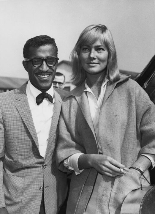 American entertainer Sammy Davis Jr. (1925 - 1990) meets his future wife, Swedish actress May Britt, on her arrival at London Airport from Hollywood, 4th June 1960.