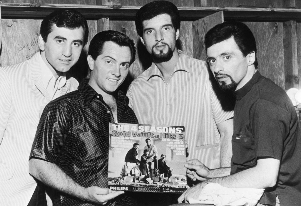 Italian-American vocal group The Four Seasons with their album 'The 4 Seasons' Gold Vault Of Hits', which has gone gold after a million dollars in sales, circa 1966. Left to right: Joe Long (1932 - 2021), Tommy DeVito, Bob Gaudio and Frankie Valli